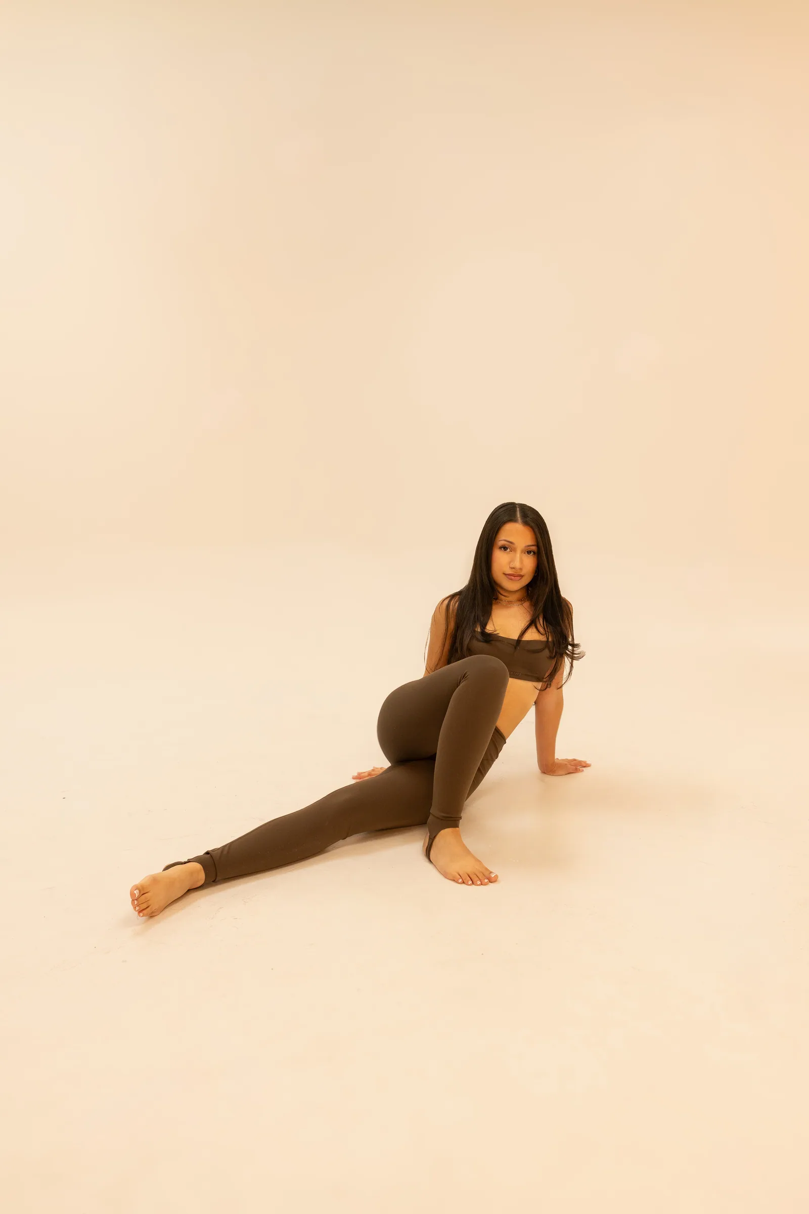 Denise in a long floor stretch, one leg extended
