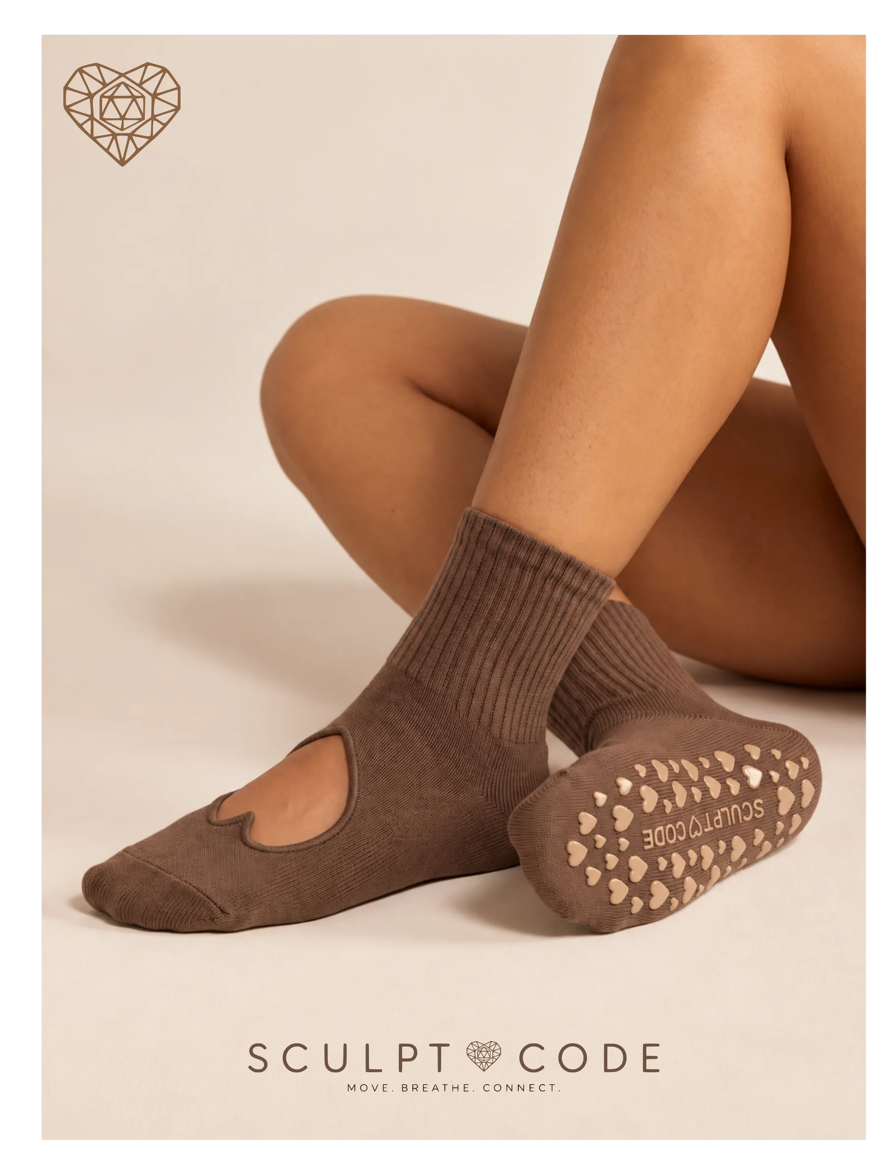 Mocha grip socks, one sole turned up to show the heart grips